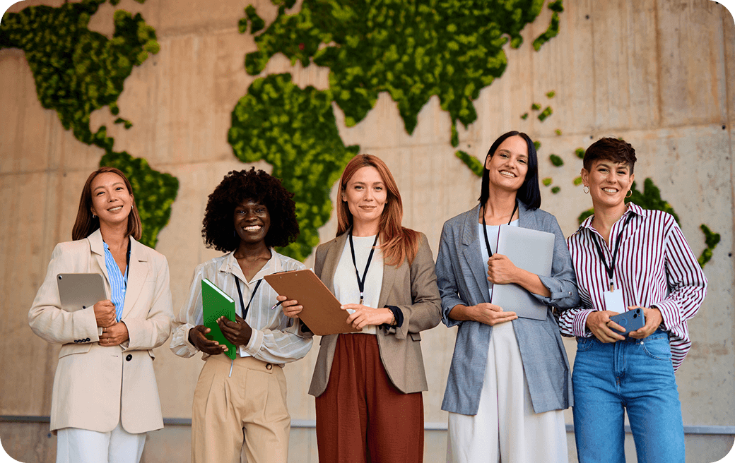 Five women standing by green world map
