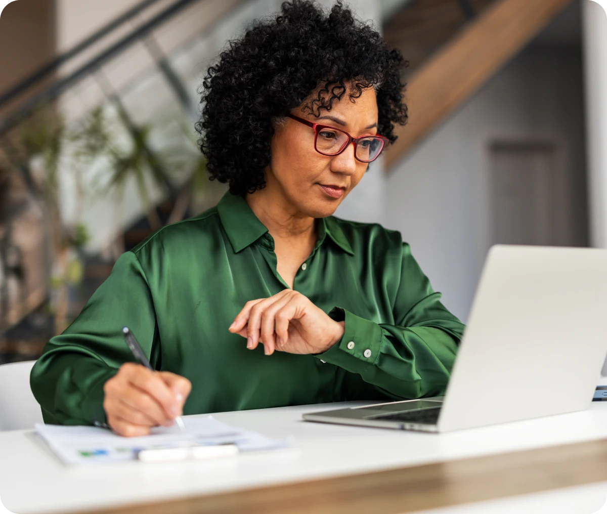 Professional woman in glasses using a laptop